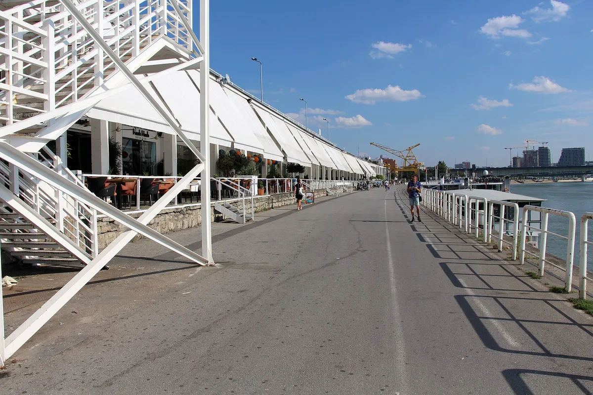 The Beton Hala waterfront in Belgrade, a strip of riverside bars and restaurants under white awnings along the Sava